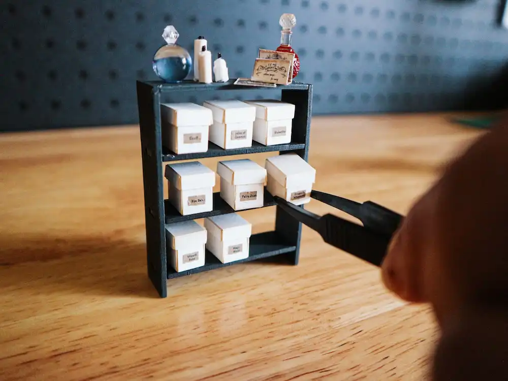 A miniature model of a wooden display shelf with mini archive boxes
