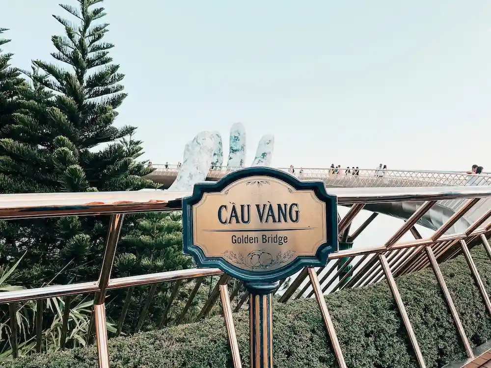 A golden sign on a bridge