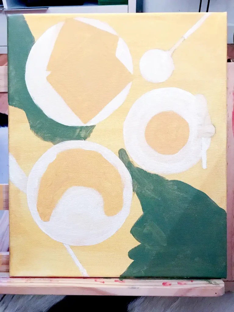 A painting canvas with base colours blocked in for brunch elements like croissant, waffles and coffee