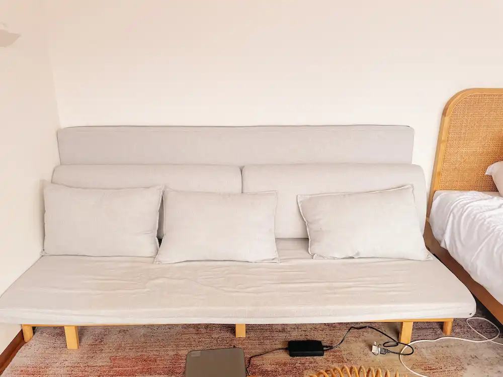 A grey three-seater couch in a glamping tent at Gramercy Village, Lake Yamanaka