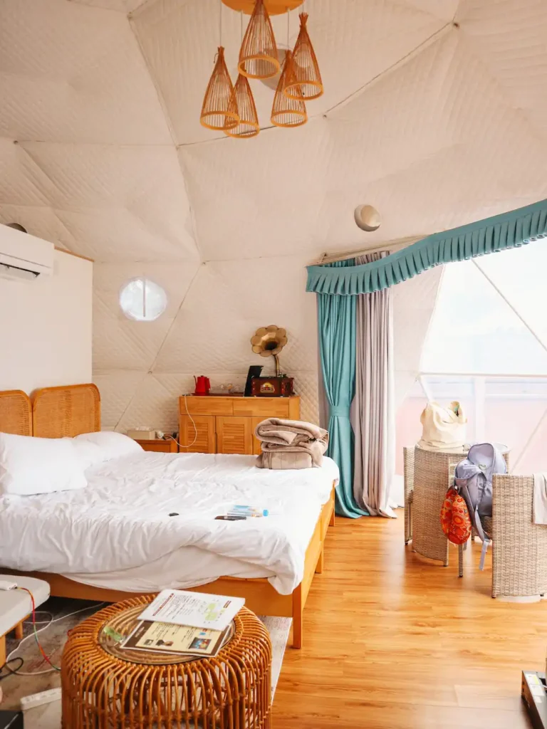The interior of Gramercy Village Glamping Dome with two beds and dining table